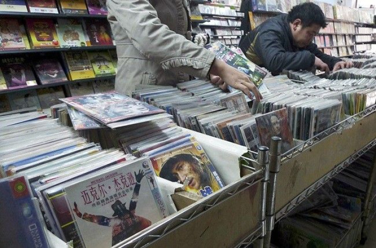 Customers select pirated DVDs at a store in Xiangyang, Hubei province December 14, 2010.