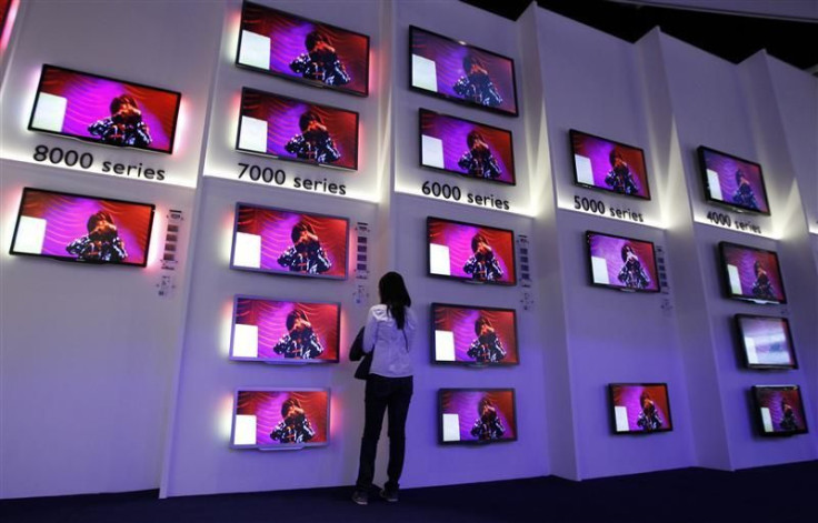 Woman looks at flat screen TV sets in Philips pavilion before opening of the IFA consumer electronics fair in Berlin