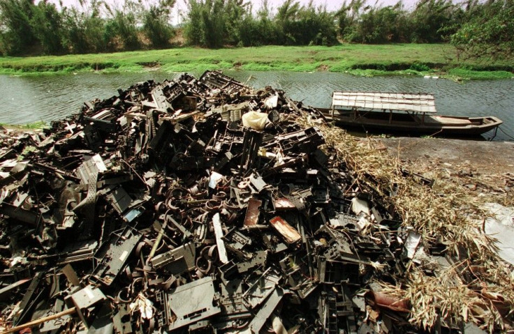 Computer waste is left along a river bank at Yaocuowei village near Guiyu in China. This image is taken from 2002.