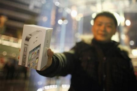 A customer show his new iPhone 4S after making the purchase at Apple's retail store in downtown Shanghai January 13, 2012.