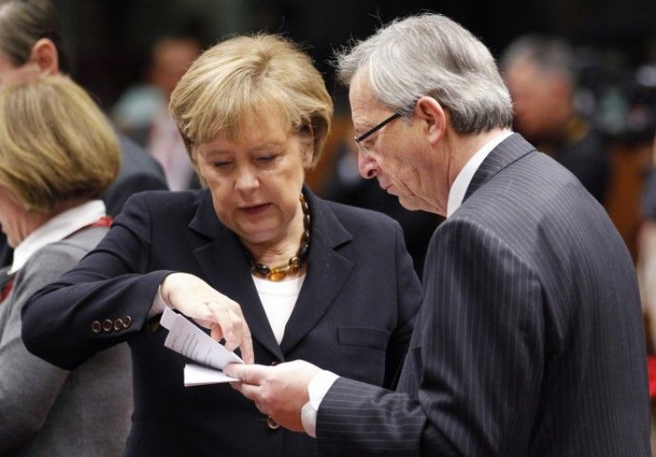 German Chancellor Merkel and Luxembourg's PM Juncker read a paper during an EU leaders summit in Brussels on Dec.17, 2010. 
