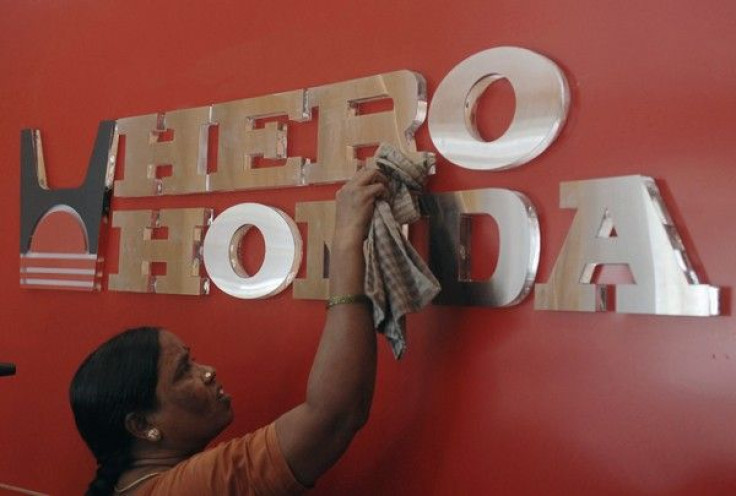 A worker cleans a Hero Honda logo inside its showroom in Hyderabad