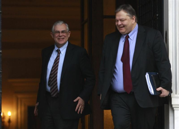 Greece&#039;s PM Papademos escorts Finance Minister Venizelos after a meeting in Athens