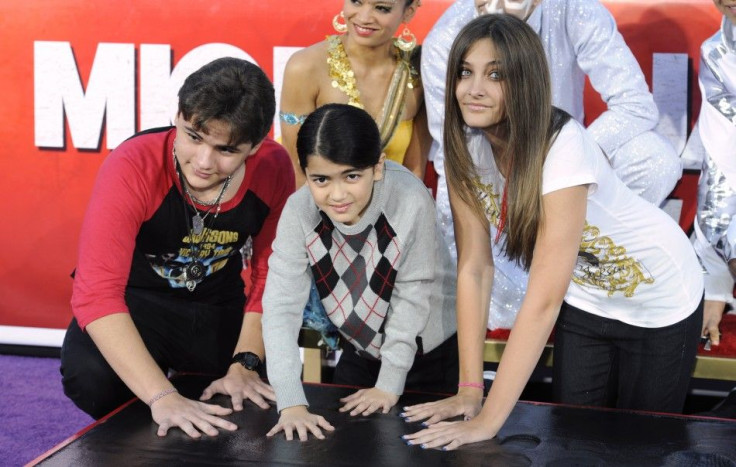 Singer Michael Jackson is immortalized in a ceremony where his children (L-R) Prince, Blanket and Paris use Jackson&#039;s shoes and gloves and their own hands to make imprints in cement in the courtyard of Hollywood&#039;s Grauman&#039;s Chinese Theatre 