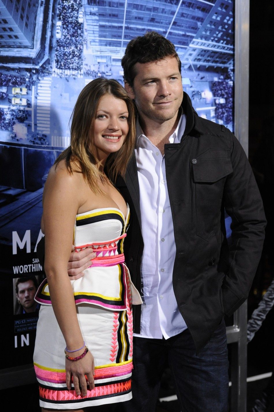 Cast member Sam Worthington R and guest Crystal Humphries attend the premiere of the film quotMan on a Ledgequot in Los Angeles