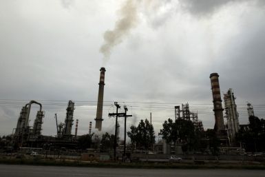 Smoke rises from the chimneys of an oil refinery on Jan. 24 near Corinth, about 50 miles west of Athens, Greece.