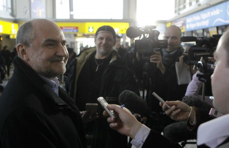 Herman Nackaerts, left, head of a delegation of the International Atomic Energy Agency, talks to journalists on his way to Iran at Vienna's international airport in Vienna January 28, 2012.
