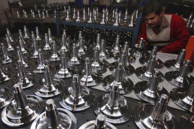 A worker performs a quality test on automobile parts at a factory in Ludhiana, in the northern Indian state of Punjab on Jan. 18, 2012.