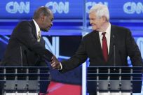 U.S. Republican presidential candidates businessman Herman Cain and former U.S. House Speaker Newt Gingrich (R) shake hands at the end of the CNN GOP National Security debate in Washington, November 22, 2011.