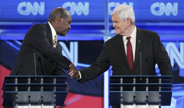 U.S. Republican presidential candidates businessman Herman Cain and former U.S. House Speaker Newt Gingrich (R) shake hands at the end of the CNN GOP National Security debate in Washington, November 22, 2011.
