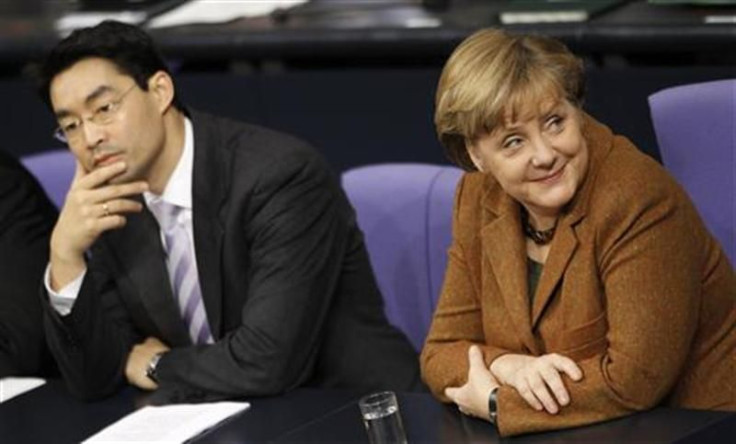 German Economy Minister Roesler and Chancellor Angela Merkel attend a session of the lower house of parliament Bundestag in Berlin