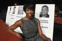 Actress Regina King poses next to a placard for nominee Laurence Fishburne at a press preview of the 18th annual Screen Actors Guild Awards showroom in Los Angeles, California