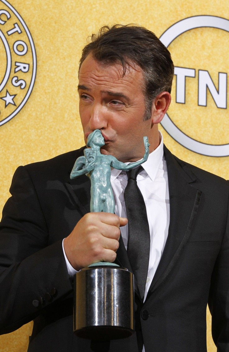 Actor Jean Dujardin kisses his award for outstanding performance by a male actor in a leading role for his performance in "The Artist" at the 18th annual Screen Actors Guild Awards in Los Angeles