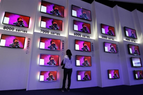 Woman looks at flat screen TV sets in Philips pavilion before opening of the IFA consumer electronics fair in Berlin