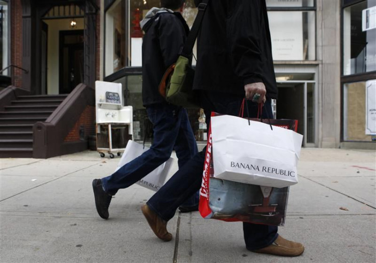 People walk along Newbury Street carrying shopping bags in Boston