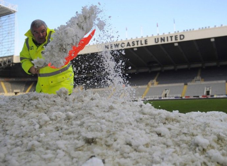 A steward clears snow from the side of the pitch, before the match against Chelsea, at St James' Park in Newcastle on 28/11/2010.