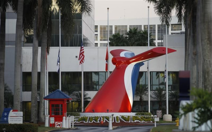 Flags are shown at half-mast outside the headquarters of Carnival Cruise Lines in Doral