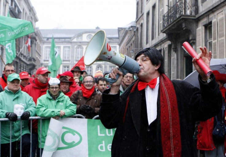 A man dressed as Prime Minister Elio Di Rupo delivers a speech as Belgian workers stage a protest in front Di Rupo&#039;s house during a national 24-hour general strike