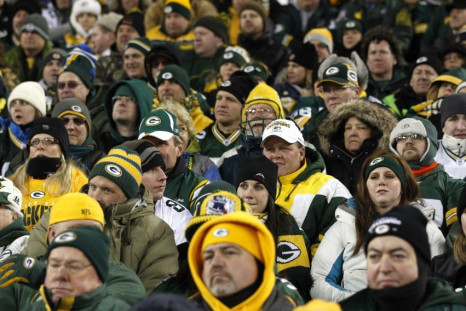 Dejected Green Bay Packers fans watch the final minutes of their game against the New York Giants in their NFL NFC Divisional playoff football game in Green Bay