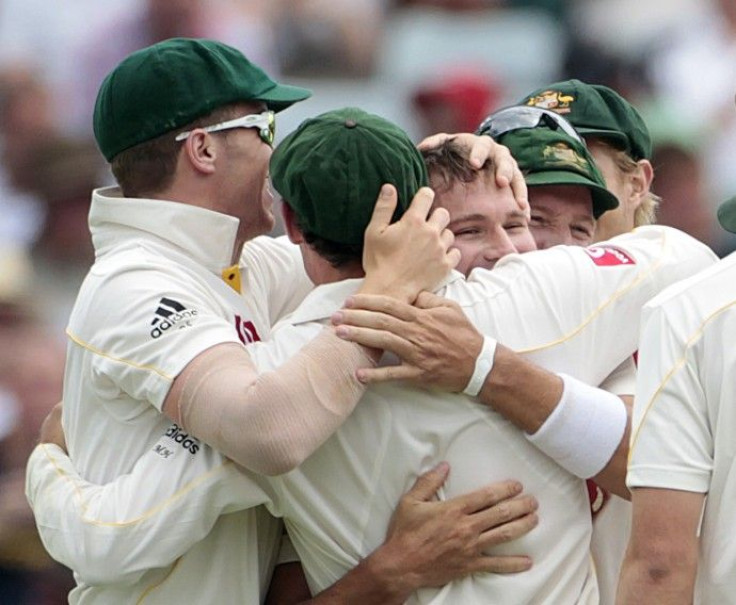 Teammates congratulate Harris for taking the wicket of Prior during the third Ashes cricket test in Perth.