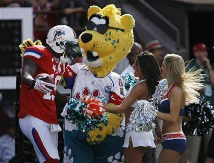 AFC wide receiver Brandon Marshall of the Miami Dolphins (L) celebrates with an NFL mascot and cheerleaders after scoring a touchdown during the second quarter of the NFL Pro Bowl at Aloha Stadium in Honolulu, Hawaii