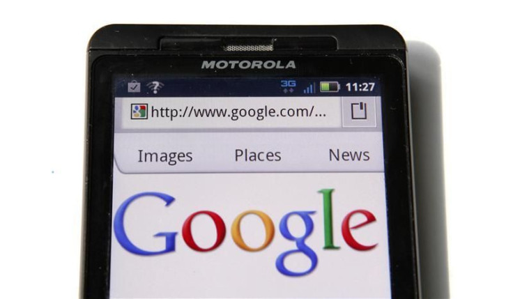 A Google homepage is displayed on a Motorola Droid phone in Washington