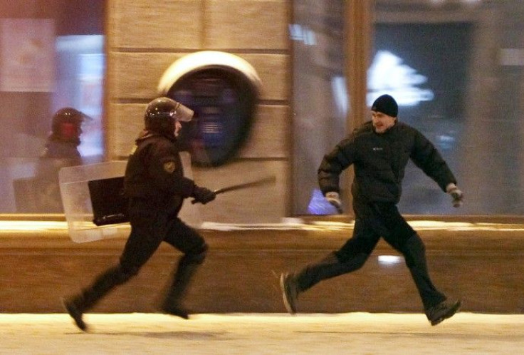 A riot policeman chases an opposition protester in Minsk