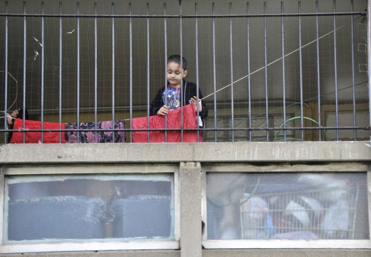 A child plays behind railings on the Robin Hood Gardens estate in Poplar in East London