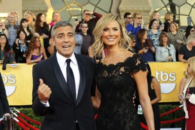 Actor George Clooney from the movie &quot;The Descendants&quot; and actress Stacy Keibler pose on arrival at the 18th annual Screen Actors Guild Awards in Los Angeles, California