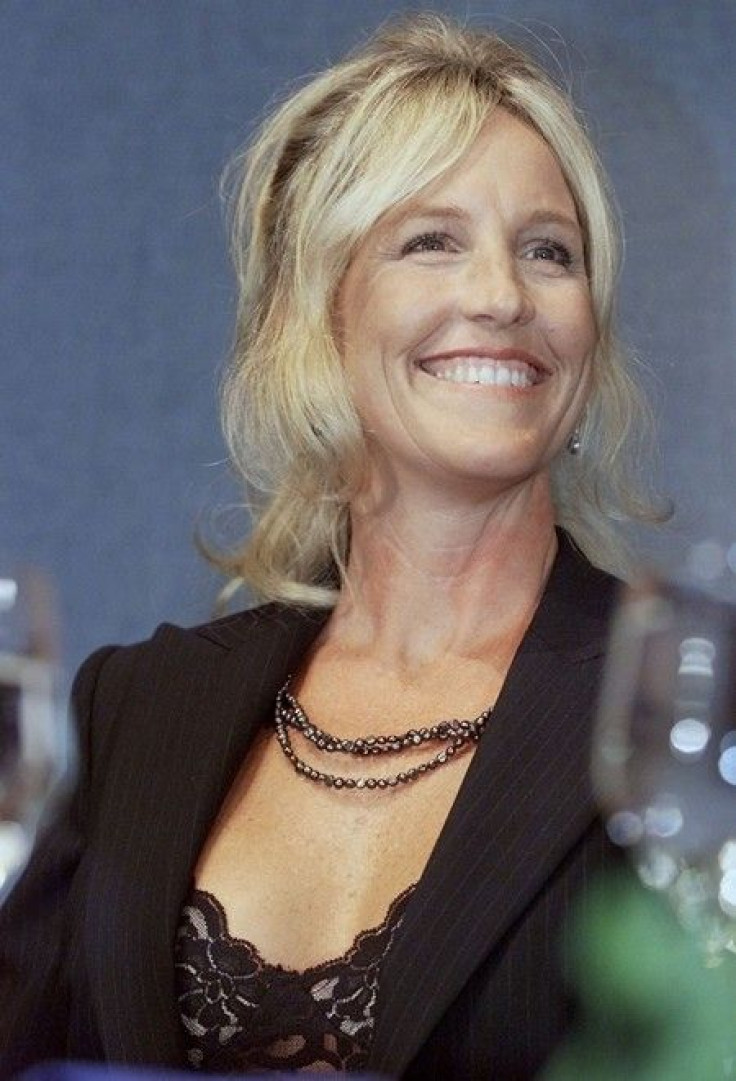 Environment activist and subject of a Hollywood movie Erin Brockovich smiles before speaking to a gathering of journalists at the National Press Club in Washington, August 16, 2001. 