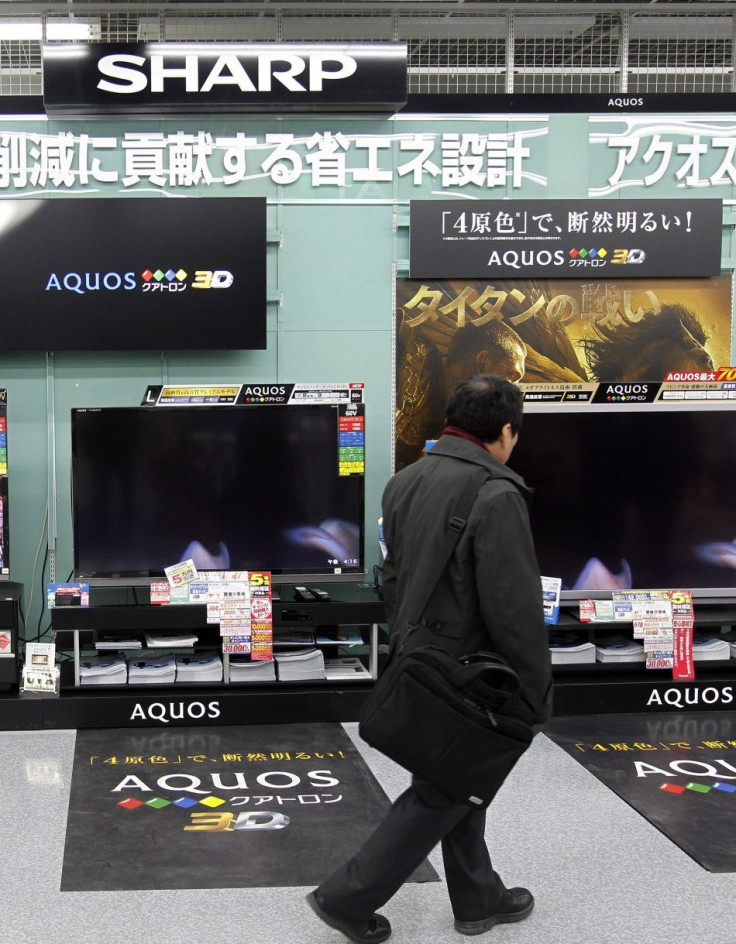 A man looks around Sharp's TV sets at an electronics store in Tokyo