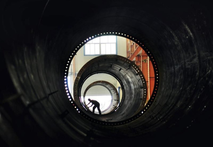 A labourer builds components of wind turbines at a wind power equipment factory in Zouping