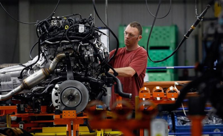 File photo of a Chrysler Group assembly worker working on bottom chassis for Chrysler Jeeps, Grand Cherokees and Dodge Durangos at Chrysler Jefferson North auto plant in Detroit