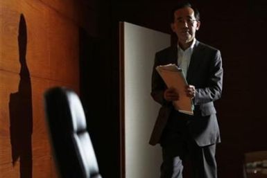 Bank of Japan Governor Masaaki Shirakawa enters a room for a news conference at the Bank of Japan in Tokyo