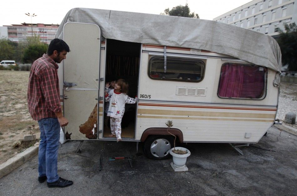Mateus Silva and his daughters at their Lisbon trailer, before being evicted