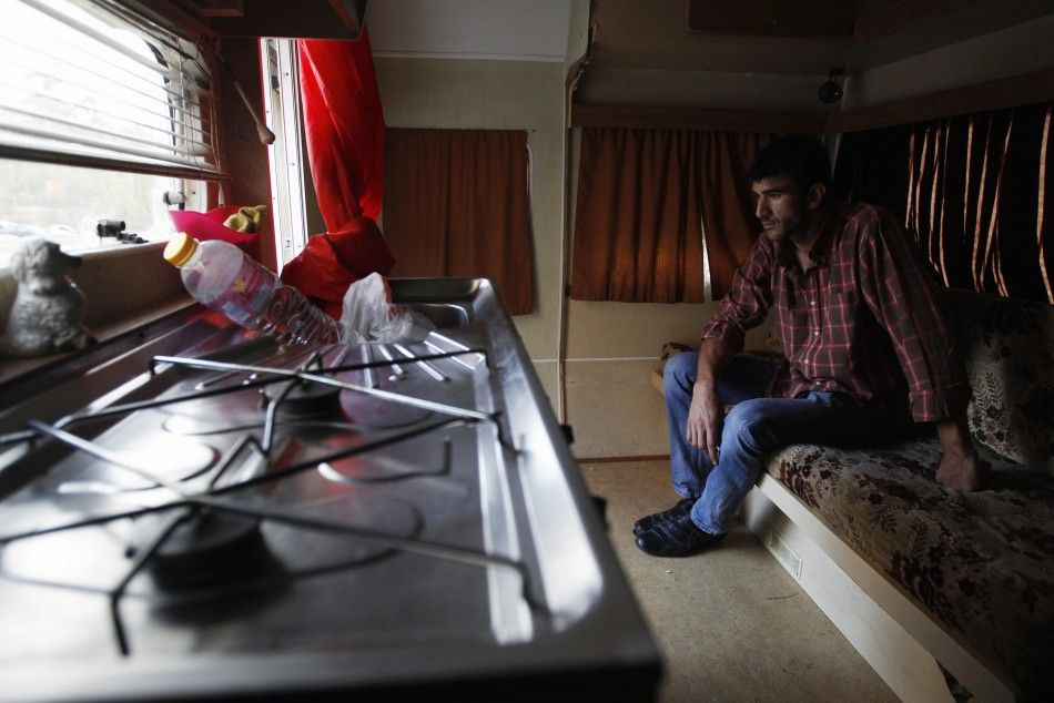 Mateus Silva speaks with a Reuters photographer inside his trailer