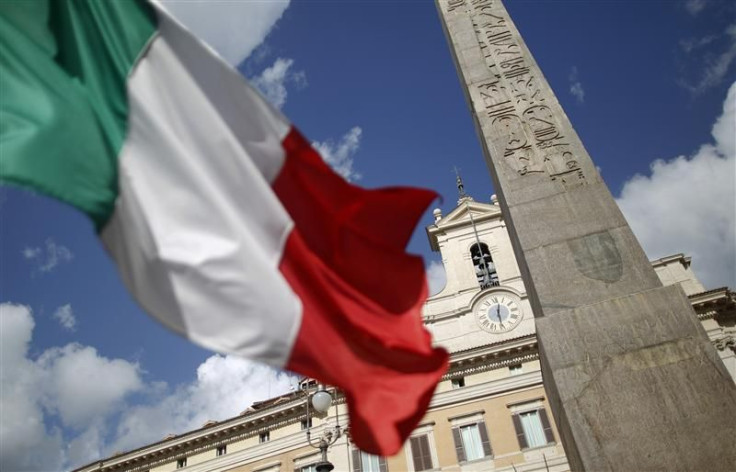 An Italian flag waves in front of the Montecitorio palace before the start of a finances vote in downtown Rome