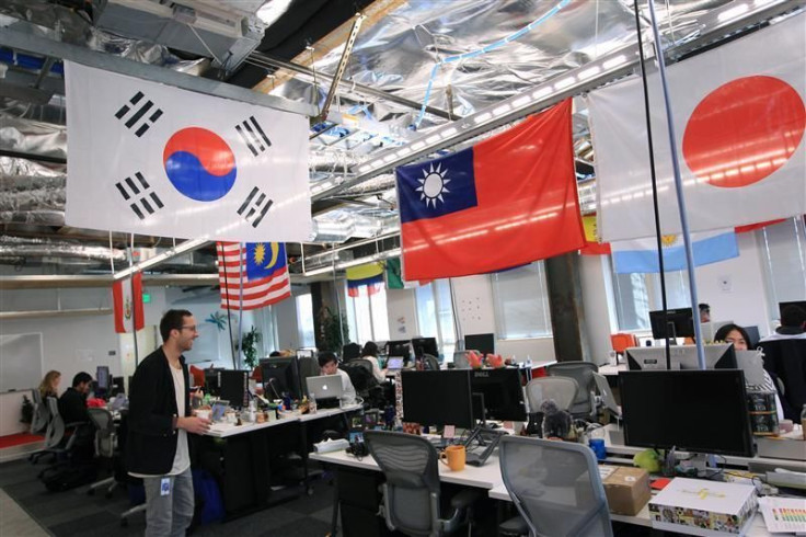 Employees work in the international user operations area at the new headquarters of Facebook in Menlo Park