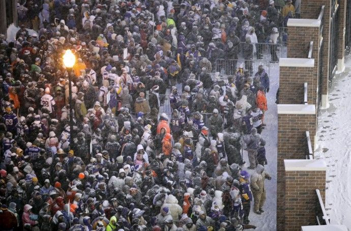 Fans wait for gates to open before start of the Vikings' outdoor NFC, NFL football game against the Bears in Minneapolis