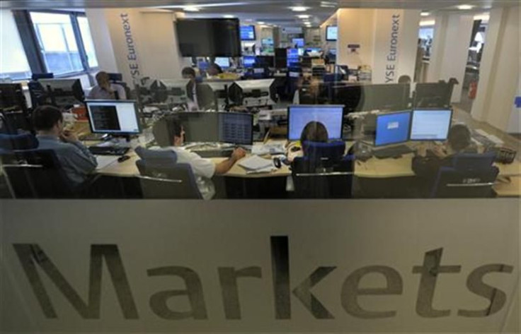 Experts work at their screens in the NYSE Euronext cash markets operations room in Paris