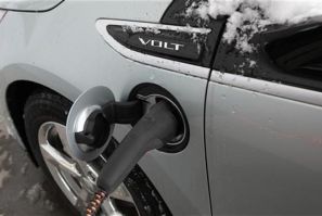 A 2012 Chevrolet Electric Volt gets charged at a charging station at a Chevrolet car sales lot in Troy, Michigan