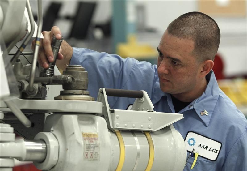 Landing gear final inspector Henao works on a piece of landing gear at AAR039s facility in Medley, Florida