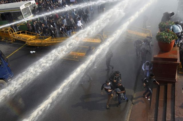 Demonstrators hit by water cannons