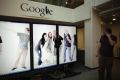 Software Engineer Arthur views a scrolling employee photo collage at the Google campus near Venice Beach, in Los Angeles