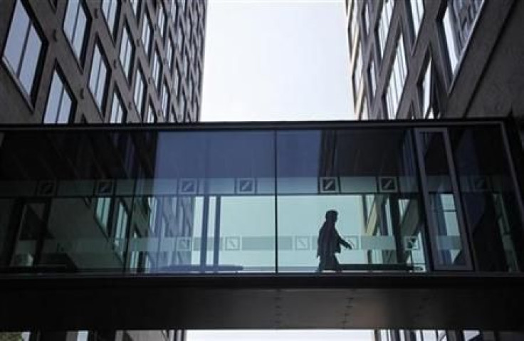An employee of the Deutsche Bankwalks along a passageway between buildings at the Deutsche Bank headquaters in Frankfurt