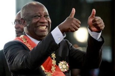 Ivory Coast's President Laurent Gbagbo flashes two thumbs-up during his inauguration at the presidential palace in Abidjan