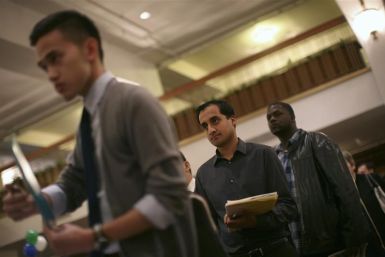 Job seekers stand in line to speak with an employer at a job fair in San Francisco