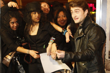Cast member Daniel Radcliffe greets fans as he arrives at a special screening of &quot;The Woman in Black&quot; in Los Angeles, California 