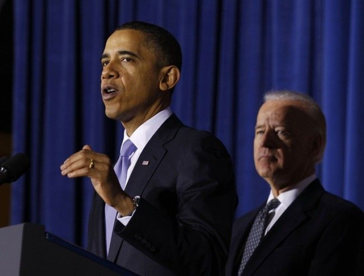 U.S. President Barack Obama (L) speaks before signing the Don't Ask, Don't Tell Repeal Act of 2010 into law as Vice President Joseph Biden listens at the U.S. Department of Interior in Washington, December 22, 2010. Obama said Wednesday that implementing 