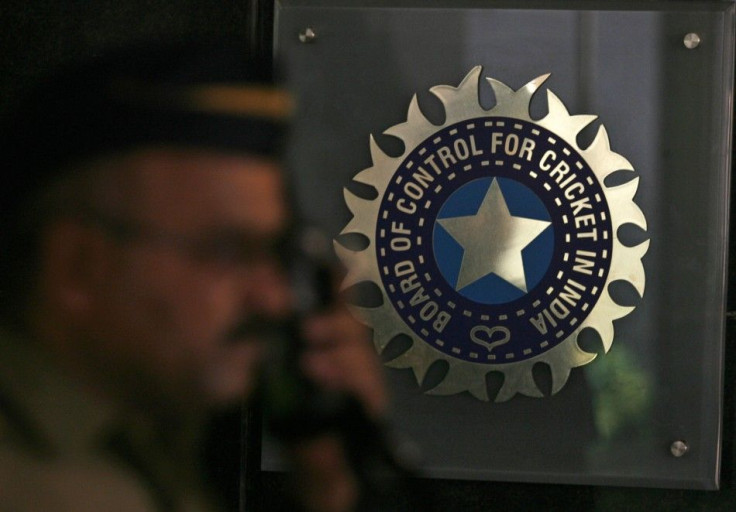 A policeman walks past a logo of the Board of Control for Cricket in India (BCCI) during a governing council meeting of the Indian Premier League (IPL) at BCCI headquarters in Mumbai April 26, 2010.